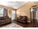 Inviting living area featuring hardwood floors, plush seating, and natural light at 8818 W Pinchot Ave, Phoenix, AZ 85037