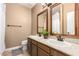 Well-lit bathroom featuring a dual sink vanity with framed mirrors and neutral-toned walls at 882 N Concord Ave, Chandler, AZ 85225