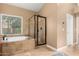 Bathroom featuring a soaking tub next to a walk-in shower, offering relaxation and convenience at 882 N Concord Ave, Chandler, AZ 85225