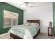 Cozy bedroom with bright walls, a large window, and a comfy queen-sized bed at 882 N Concord Ave, Chandler, AZ 85225