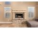 Elegant fireplace featuring decorative tile, framed by windows, creating a cozy focal point in the living space at 882 N Concord Ave, Chandler, AZ 85225