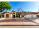 Charming single-story home featuring a three-car garage, well-maintained yard with mature trees, and a red tile roof at 882 N Concord Ave, Chandler, AZ 85225