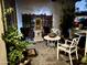 Picturesque front porch at night featuring cozy seating, a water feature, and lush plants for a serene ambiance at 882 N Concord Ave, Chandler, AZ 85225