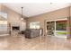 Spacious living room featuring a vaulted ceiling, fireplace, and access to the backyard, creating an open atmosphere at 882 N Concord Ave, Chandler, AZ 85225