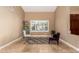 Bright living room with large window, neutral walls, tile floors, and stylish seating arrangement at 882 N Concord Ave, Chandler, AZ 85225