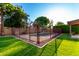 Inviting fenced in in-ground pool with lush green landscaping surrounding the entire yard at 882 N Concord Ave, Chandler, AZ 85225