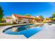 A refreshing in-ground pool reflects the home's tile roof and blue sky on a sunny day at 882 N Concord Ave, Chandler, AZ 85225