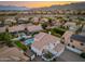 Aerial view displays the backyard pool, covered patio and landscaped yard at 13 W Silverwood Dr, Phoenix, AZ 85045