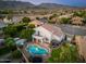 A distant aerial view highlights the pool, patio, and meticulously kept landscaping of the backyard at 13 W Silverwood Dr, Phoenix, AZ 85045