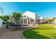 Spacious backyard with a trampoline, lush artificial turf, a pool, and a charming pergola seating area at 13 W Silverwood Dr, Phoenix, AZ 85045