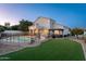 Expansive backyard with pool, patio, manicured lawn, pergola, and trampoline for outdoor entertainment at 13 W Silverwood Dr, Phoenix, AZ 85045