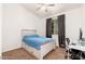 Well-lit bedroom with bed, a ceiling fan, and a workspace near the window at 13 W Silverwood Dr, Phoenix, AZ 85045