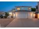 Charming two-story home with a three-car garage and well-lit exterior, showcasing curb appeal at 13 W Silverwood Dr, Phoenix, AZ 85045