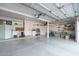 Spacious garage with epoxy floors, storage cabinets, shelving, and overhead lighting at 13 W Silverwood Dr, Phoenix, AZ 85045