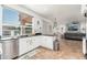 Modern kitchen with stainless steel appliances, white cabinets, and an open view to living area at 13 W Silverwood Dr, Phoenix, AZ 85045