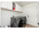 Laundry room featuring a modern washer and dryer with white storage cabinets at 13 W Silverwood Dr, Phoenix, AZ 85045