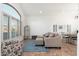 Bright living room with a large window, tile flooring, and cozy furnishings at 13 W Silverwood Dr, Phoenix, AZ 85045