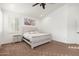 This well-lit main bedroom features neutral walls, carpet, a ceiling fan, and a decorative art piece at 13 W Silverwood Dr, Phoenix, AZ 85045