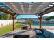 Charming pergola-covered outdoor living space with a comfortable seating area and a view of the backyard at 13 W Silverwood Dr, Phoenix, AZ 85045