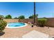 Backyard with pool, palm tree and brick features is the perfect spot for relaxing outdoors at 13373 W Boca Raton Rd, Surprise, AZ 85379