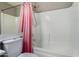 Bathroom featuring a shower and bathtub combo, with tile backsplash and pink curtain at 13373 W Boca Raton Rd, Surprise, AZ 85379