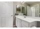 Bathroom with white vanity, tile flooring, and well-lit mirror at 13373 W Boca Raton Rd, Surprise, AZ 85379