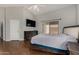Well-lit bedroom featuring laminate floors, backyard access, and neutral wall colors at 13373 W Boca Raton Rd, Surprise, AZ 85379