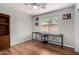 Bedroom with ceiling fan, neutral paint, wood floors and large window for natural light at 13373 W Boca Raton Rd, Surprise, AZ 85379