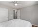 Cozy bedroom with carpet floors, ceiling fan, and convenient closet access at 13373 W Boca Raton Rd, Surprise, AZ 85379