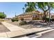 Exterior side view of a single-story home showcasing desert landscaping with solar panels at 13373 W Boca Raton Rd, Surprise, AZ 85379