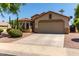 Inviting single-story home with a desert-landscaped front yard, two-car garage, and tiled roof at 13373 W Boca Raton Rd, Surprise, AZ 85379