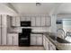 Well-lit kitchen with stainless steel appliances, white subway tile backsplash, and granite countertops at 13373 W Boca Raton Rd, Surprise, AZ 85379