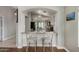Open kitchen view features breakfast bar seating and contemporary finishes with granite countertops at 13373 W Boca Raton Rd, Surprise, AZ 85379