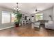 Bright and airy living room with hardwood flooring, contemporary furniture and a vaulted ceiling at 13373 W Boca Raton Rd, Surprise, AZ 85379