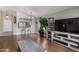 Open-concept living room features stylish furnishings and hardwood flooring with ample natural light at 13373 W Boca Raton Rd, Surprise, AZ 85379