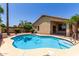 Backyard pool with lush landscaping and rock area offers an outdoor oasis for swimming and relaxation at 13373 W Boca Raton Rd, Surprise, AZ 85379