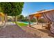 Inviting backyard with a covered patio, outdoor dining area, a sparkling pool, and relaxing lounge spaces at 13636 W Calavar Rd, Surprise, AZ 85379
