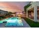 Resort-style backyard with sparkling pool, covered patio, and a cabana-covered lounge area at 13636 W Calavar Rd, Surprise, AZ 85379