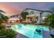 Beautiful backyard with a sparkling pool, covered patio and relaxing lounge area at 13636 W Calavar Rd, Surprise, AZ 85379