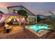 Enjoy the backyard oasis featuring a sparkling pool, covered patio and gazebo-covered lounge area at 13636 W Calavar Rd, Surprise, AZ 85379