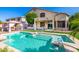 Spacious backyard with a pool, covered patio, and a charming cabana for relaxation and entertaining at 13636 W Calavar Rd, Surprise, AZ 85379