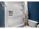 Tiled bathroom featuring shower and tub combo with decorative shower curtain and niche at 13636 W Calavar Rd, Surprise, AZ 85379