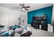 Bedroom with a large bed, ceiling fan, and en-suite bathroom at 13636 W Calavar Rd, Surprise, AZ 85379