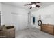 Well-lit carpeted bedroom features closet, fan, and dresser at 13636 W Calavar Rd, Surprise, AZ 85379