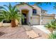 Inviting desert home featuring a grand archway entrance and desert landscaping at 13636 W Calavar Rd, Surprise, AZ 85379