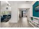 Open hallway with decorative teal accent wall leading to the living area and bedroom at 13636 W Calavar Rd, Surprise, AZ 85379