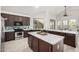 Well-appointed kitchen with stainless steel appliances, an island with seating, and modern backsplash at 13636 W Calavar Rd, Surprise, AZ 85379