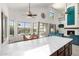 Bright, open kitchen featuring marble countertops, a dining area, and views of the backyard pool at 13636 W Calavar Rd, Surprise, AZ 85379