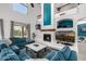 Comfortable living room with plush blue sofas, a fireplace, and decorative shelving at 13636 W Calavar Rd, Surprise, AZ 85379