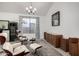 Cozy living room featuring stylish seating, a modern lamp, and a chic rug at 13636 W Calavar Rd, Surprise, AZ 85379